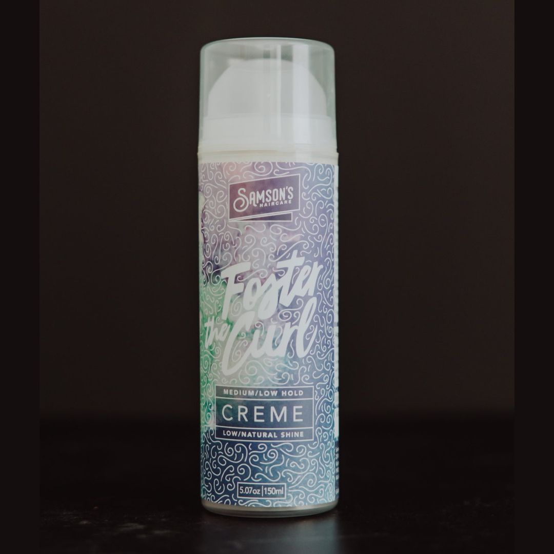 A 100ml aerosol can of Samson's Haircare Foster Curl Creme, featuring a white cap and a patterned label with a green-to-blue gradient and white swirl designs, set against a dark background.