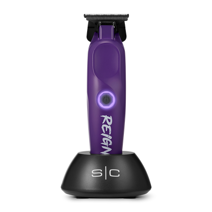 Purple hair trimmer with black stand on a white background