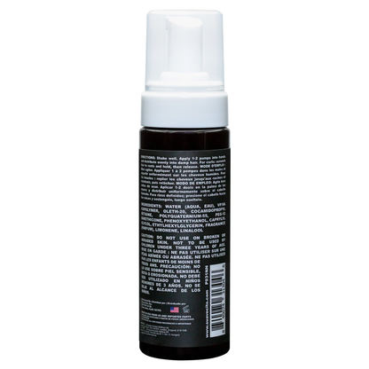 Suavecito Curl Mousse brown bottle with white pump cap on white background showing the back side of the bottle listing ingredients etc