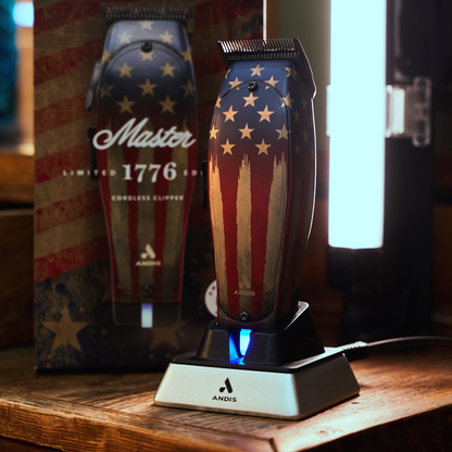 Andis Master 1776 cordless clipper on charging stand with retail packaging box in barbershop setting