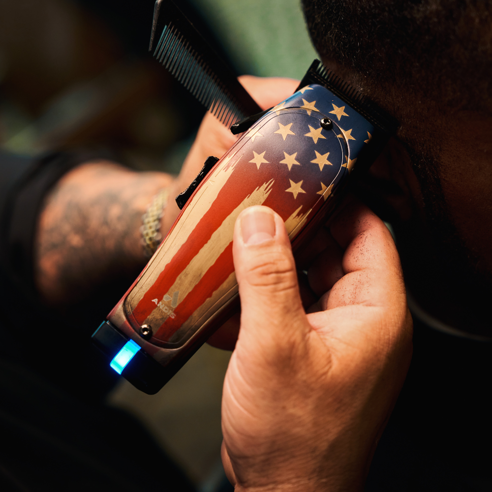 Close up of barber combing hair while using Andis Master 1776 Limited Edition clipper for precise fade