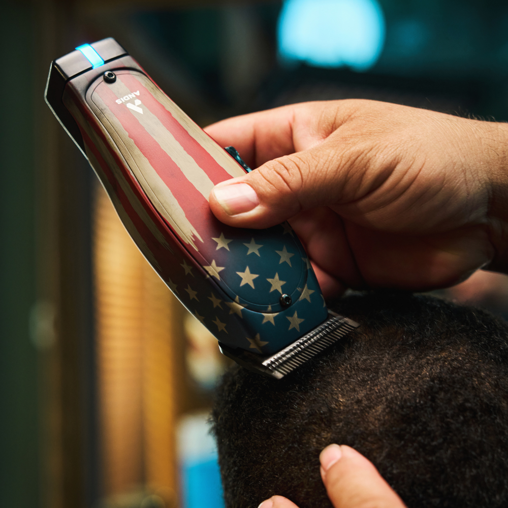 Barber using Andis Master 1776 Limited Edition cordless clipper for a fade haircut in the salon