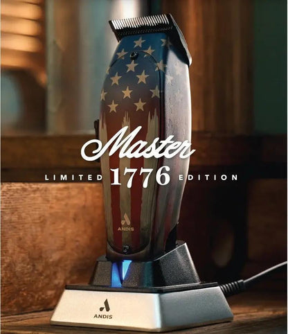 Andis Master Limited 1776 Edition clipper resting in charging dock on wood barbershop counter