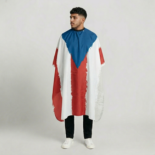 Person wearing a colorful cape with red, white, and blue sections on a plain background